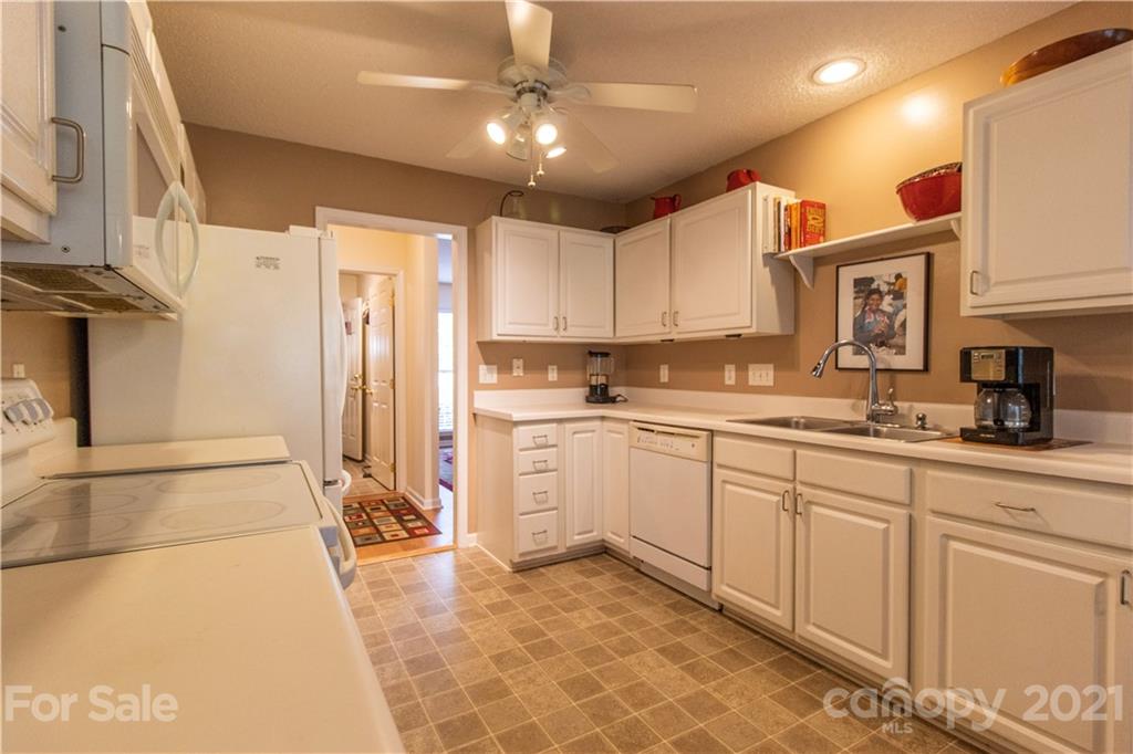 67 Rolling Meadow Road Fletcher, NC 28732 - Photo 13 of 39 a kitchen with granite countertop a sink cabinets stainless steel appliances and a counter top space
