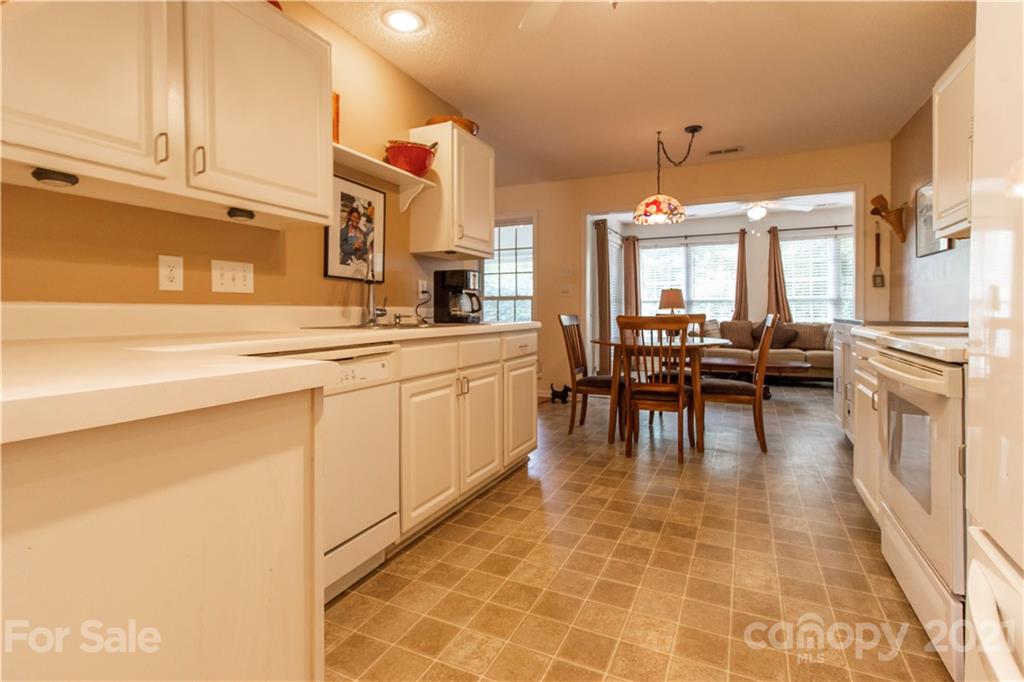 67 Rolling Meadow Road Fletcher, NC 28732 - Photo 15 of 39 a kitchen with stainless steel appliances granite countertop a stove a sink and a refrigerator