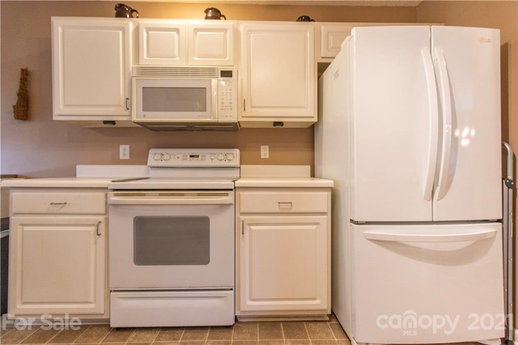67 Rolling Meadow Road Fletcher, NC 28732 - Photo 16 of 39 a kitchen with stainless steel appliances white cabinets and a refrigerator