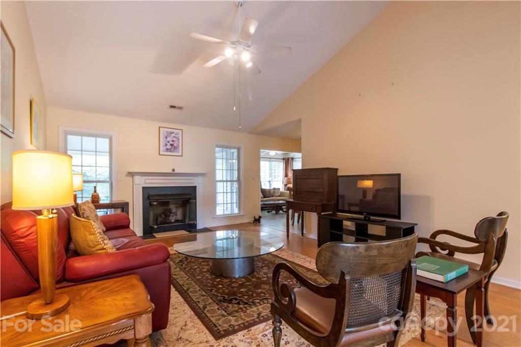 67 Rolling Meadow Road Fletcher, NC 28732 - Photo 4 of 39 a living room with furniture a fireplace and a flat screen tv