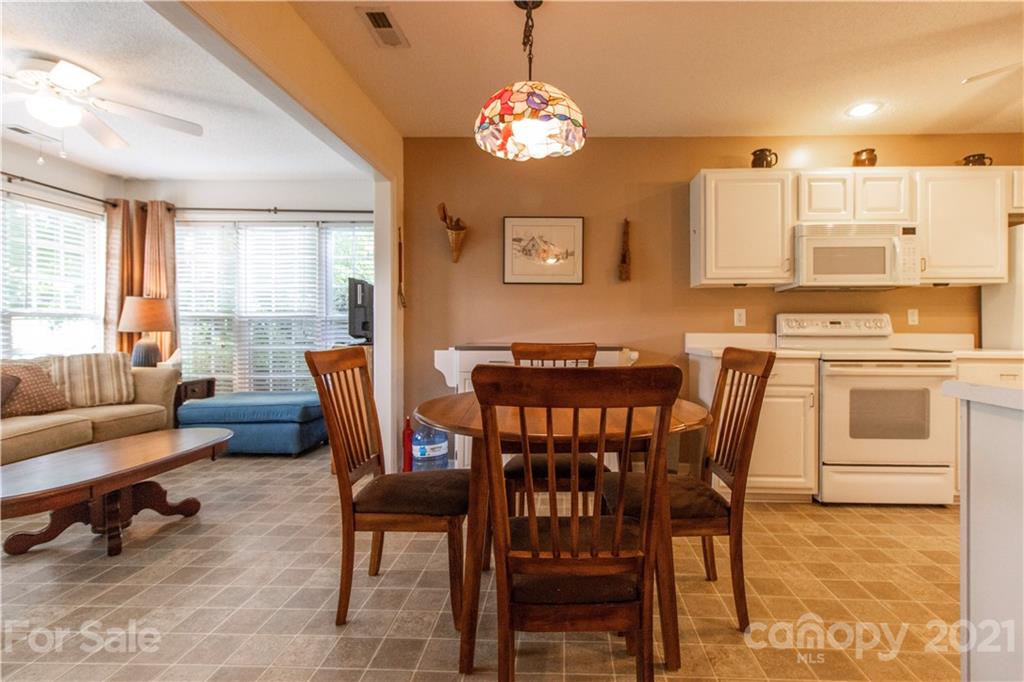 67 Rolling Meadow Road Fletcher, NC 28732 - Photo 8 of 39 a view of a dining room with furniture and a chandelier