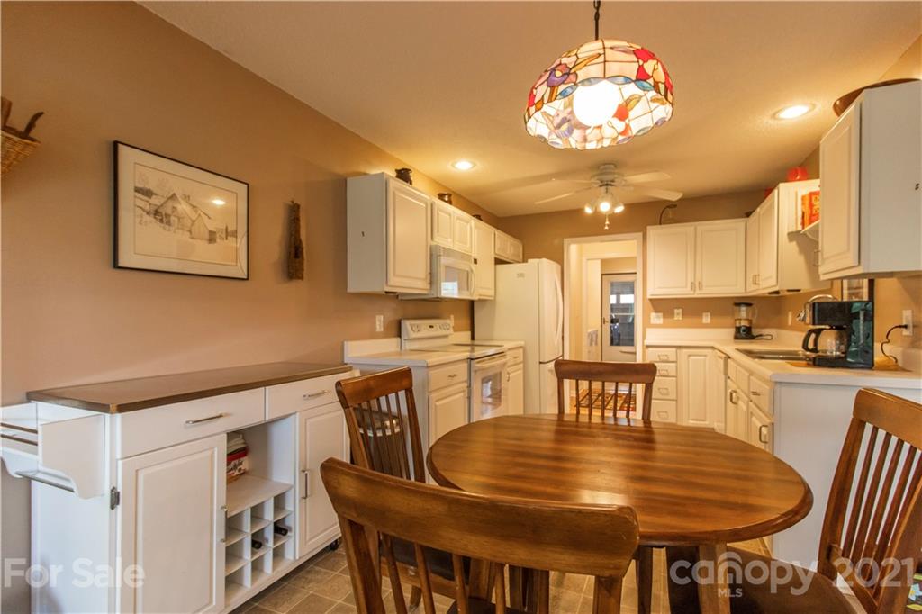 67 Rolling Meadow Road Fletcher, NC 28732 - Photo 9 of 39 a view of a dining room with furniture and a chandelier