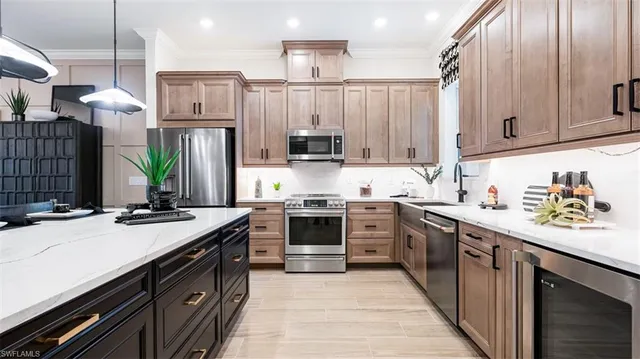 a kitchen with stainless steel appliances a sink stove and cabinets