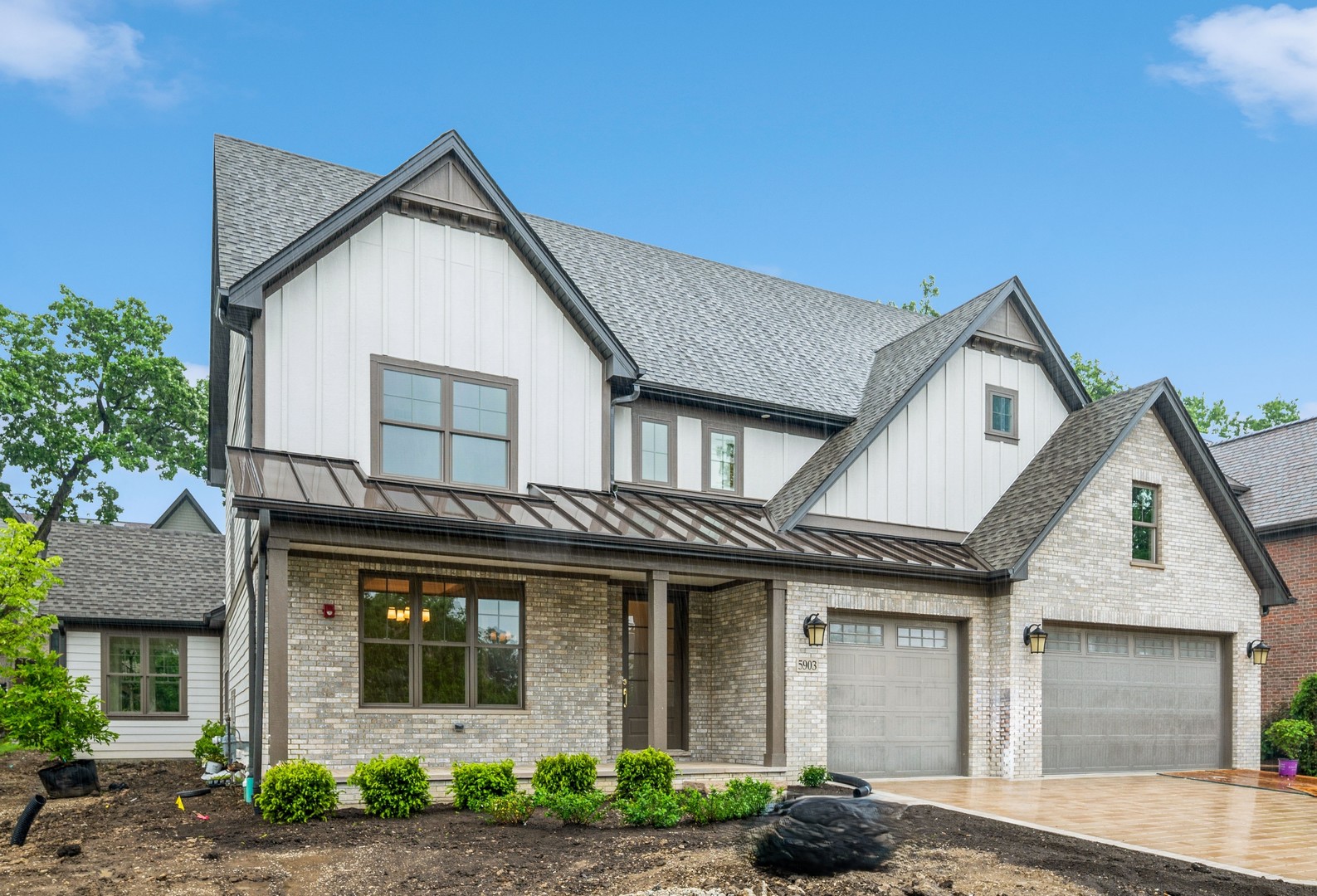 5903 Timber Trails Boulevard Western Springs, IL 60558 - Photo 1 of 30 a view of a white house with large windows and a small yard