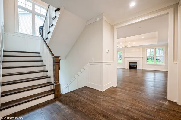 a view of a livingroom with wooden floor fireplace and windows