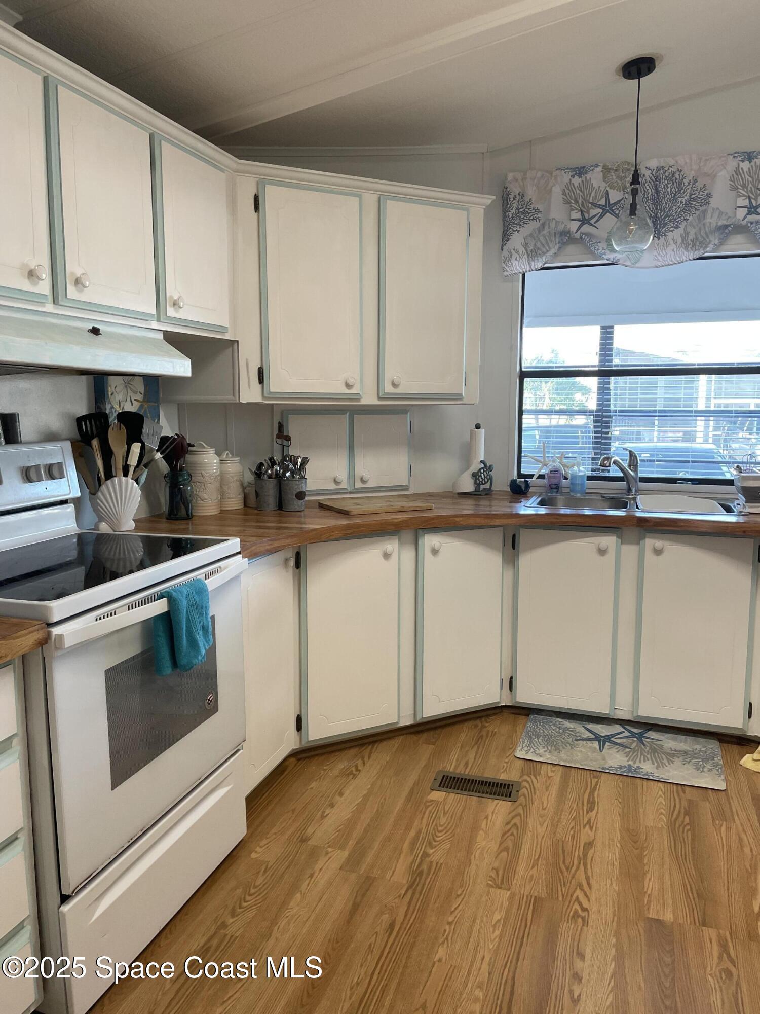 505 Puffin Drive Barefoot Bay, FL 32976 - Photo 4 of 8 a kitchen with a sink and cabinets