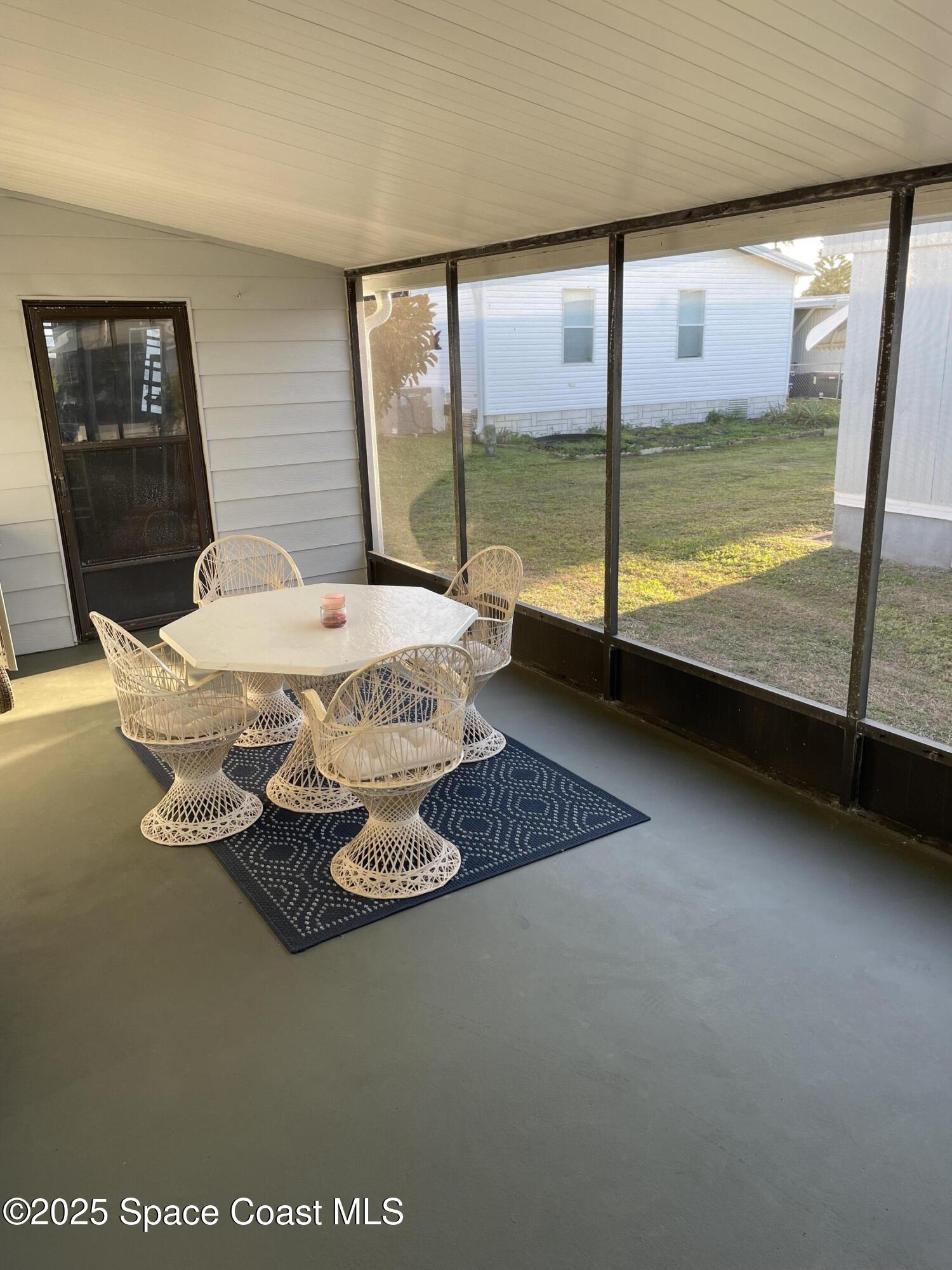 505 Puffin Drive Barefoot Bay, FL 32976 - Photo 7 of 8 a dining room with furniture