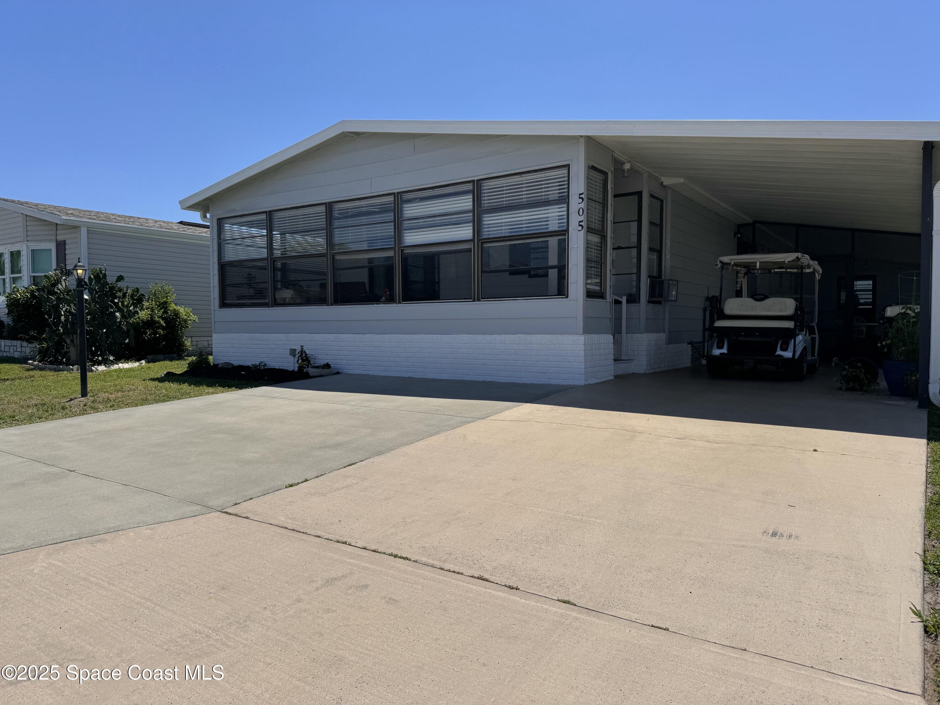 505 Puffin Drive Barefoot Bay, FL 32976 - Photo 8 of 8 a view of a car garage