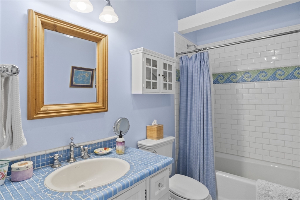 28 Bosworth Road Nantucket, MA 02554 - Photo 22 of 34 a bathroom with a granite countertop toilet sink and mirror