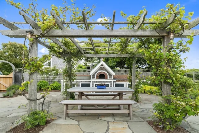 a view of a house with a yard and potted plants
