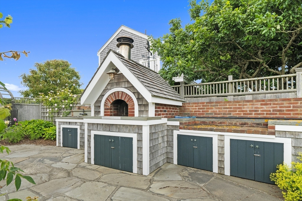 28 Bosworth Road Nantucket, MA 02554 - Photo 31 of 34 a view of a kitchen with a sink and a fireplace