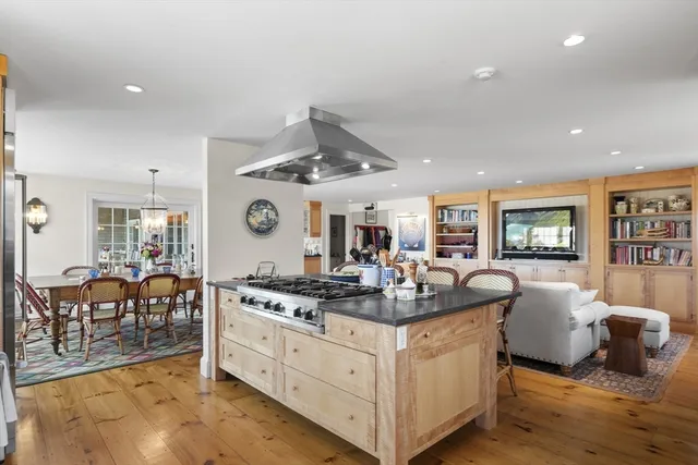 a very nice looking living room with wooden floor and furniture