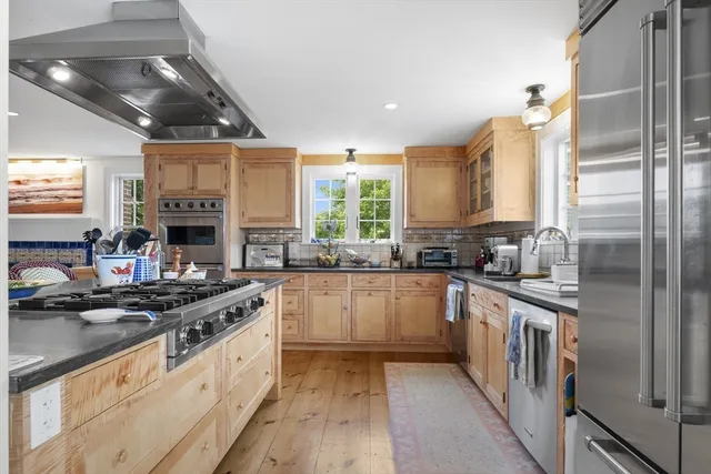 a kitchen with stainless steel appliances granite countertop a stove and a sink