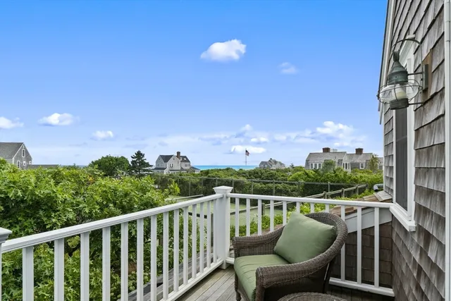 a balcony with wooden floor and outdoor space