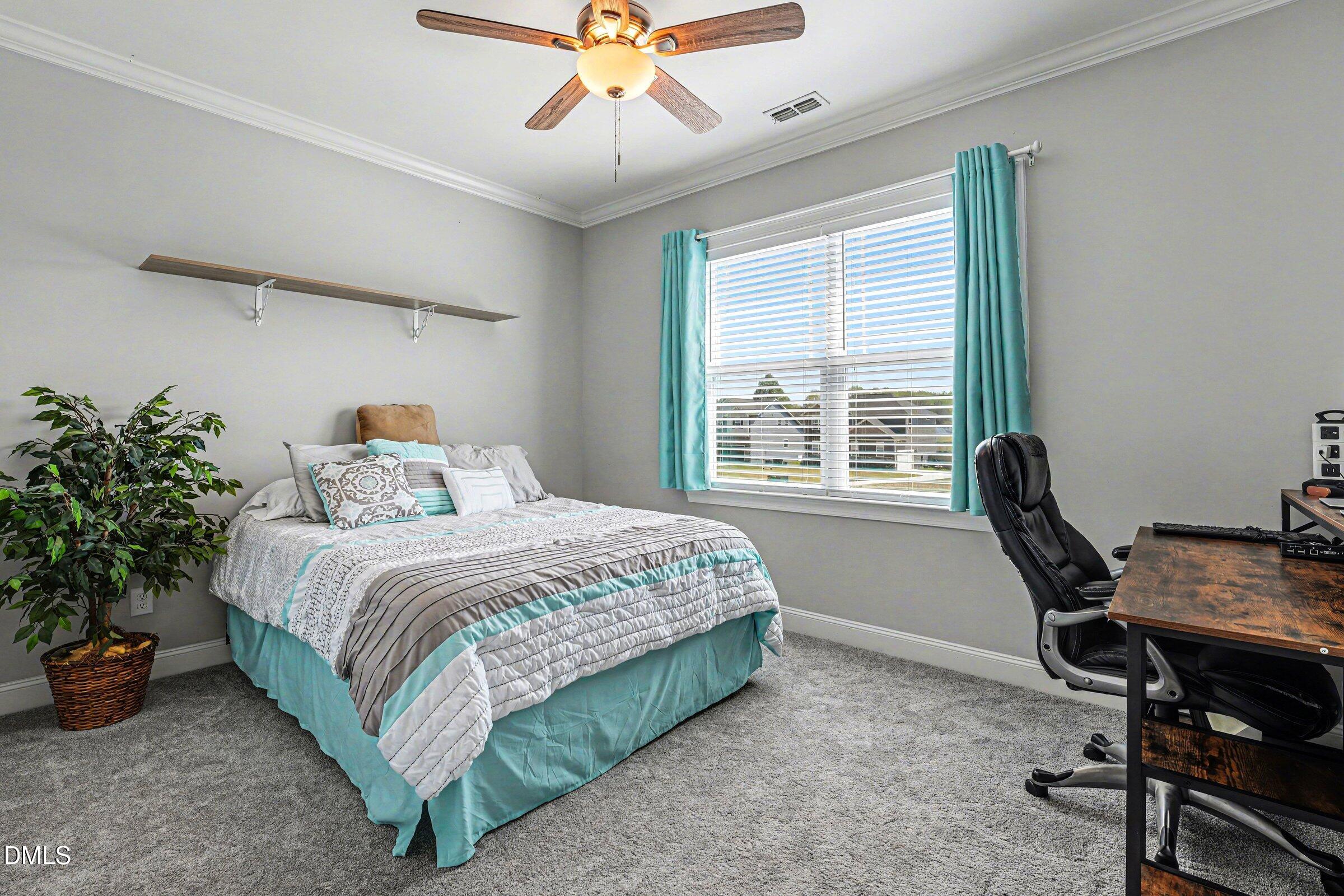 130 Aylebury Ridge Zebulon, NC 27597 - Photo 18 of 41 a bedroom with a bed table chair and a window