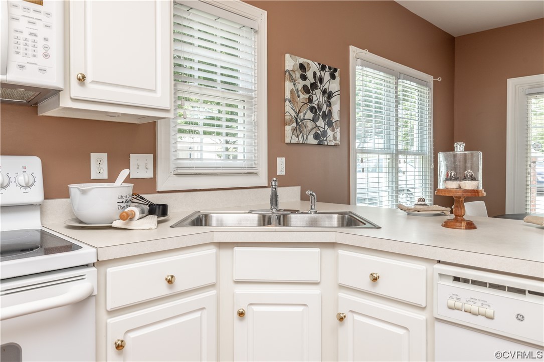 2152 Magnolia Grove Way, Unit 2152 Midlothian, VA 23113 - Photo 13 of 38 a kitchen with cabinets appliances a sink and a window