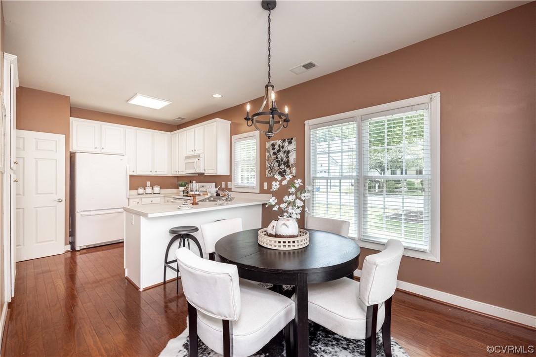 2152 Magnolia Grove Way, Unit 2152 Midlothian, VA 23113 - Photo 14 of 38 a view of a dining room with furniture window and wooden floor