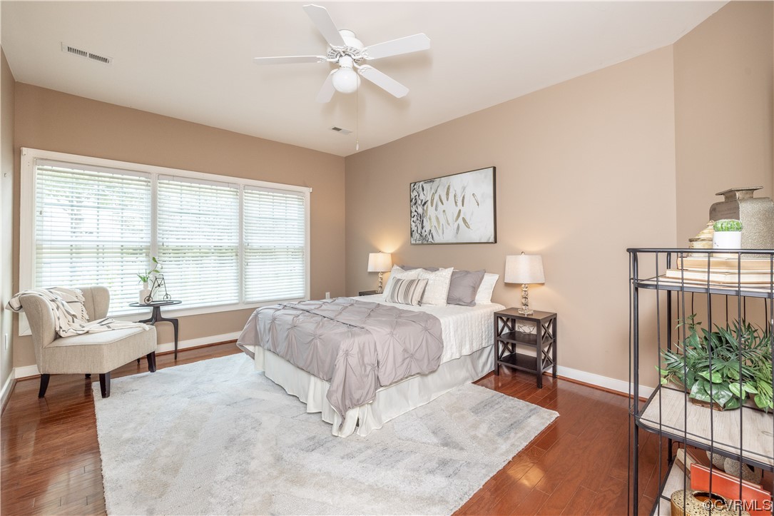 2152 Magnolia Grove Way, Unit 2152 Midlothian, VA 23113 - Photo 18 of 38 a spacious bedroom with a bed a couch and a potted plant