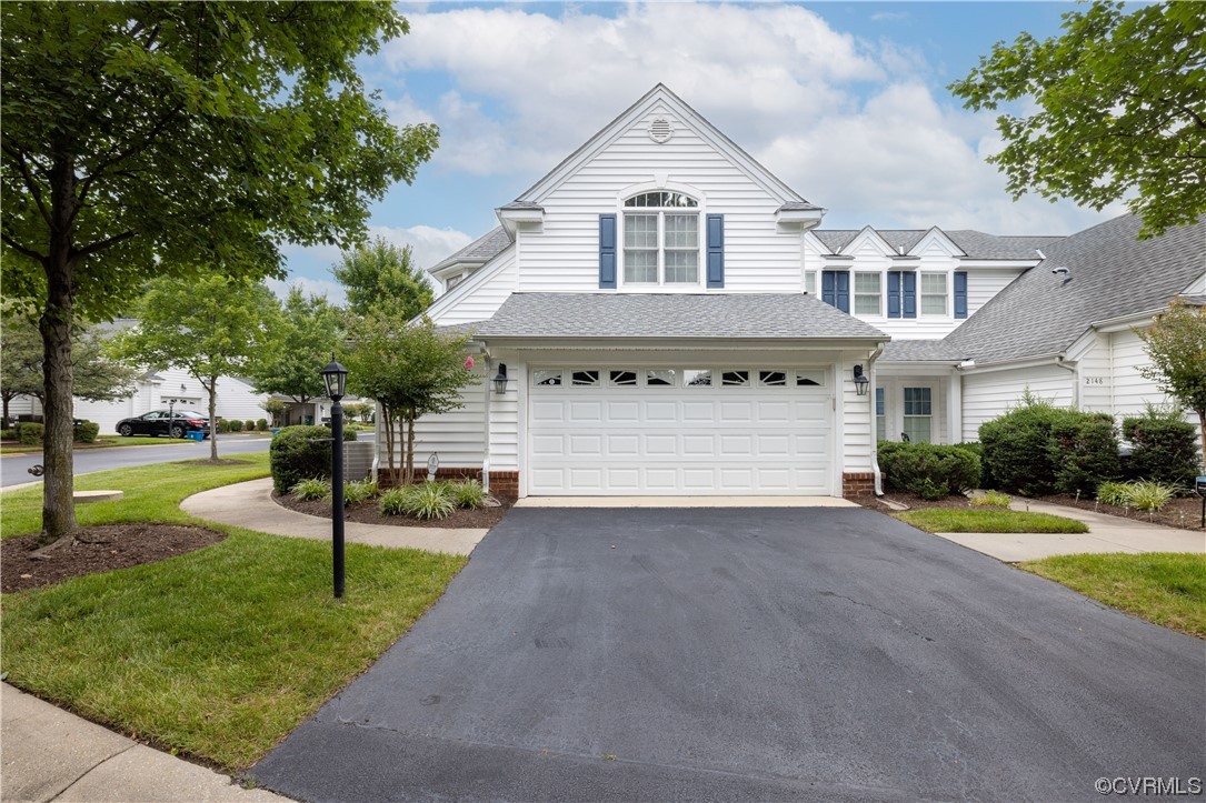 2152 Magnolia Grove Way, Unit 2152 Midlothian, VA 23113 - Photo 2 of 38 a front view of a house with a yard and garage
