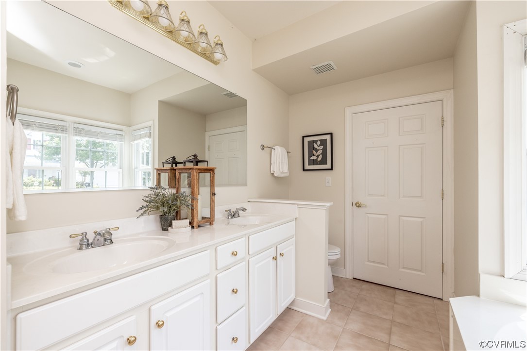 2152 Magnolia Grove Way, Unit 2152 Midlothian, VA 23113 - Photo 21 of 38 a bathroom with a double vanity sink a mirror and a bathtub