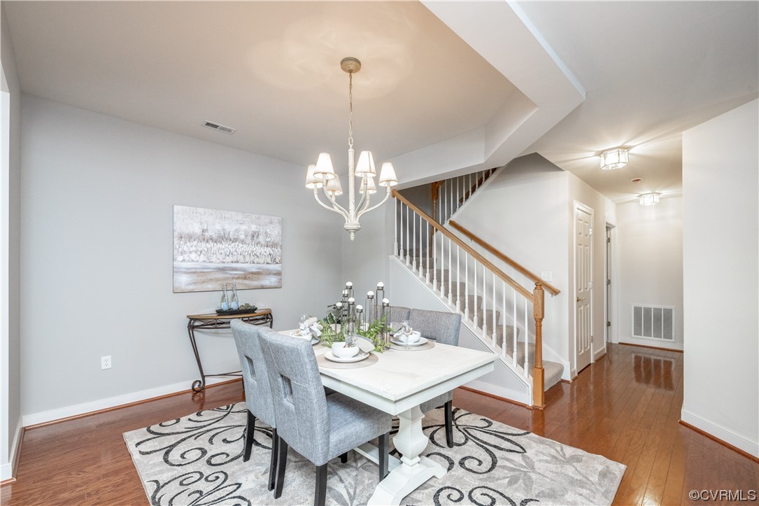 2152 Magnolia Grove Way, Unit 2152 Midlothian, VA 23113 - Photo 9 of 38 a view of a dining room with furniture wooden floor and chandelier