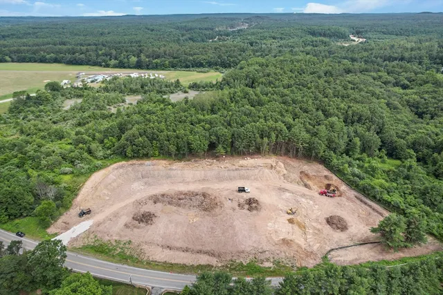 a view of a field with an ocean view