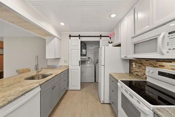a kitchen with a sink stove and refrigerator