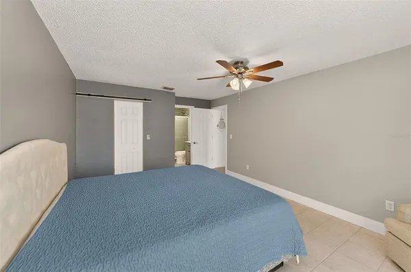 a view of a livingroom with a ceiling fan and wooden floor