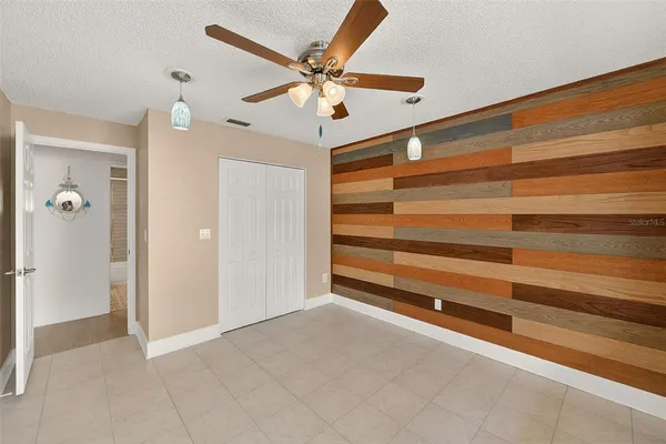 a view of room with a ceiling fan and a ceiling fan