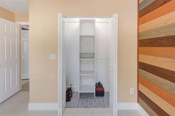 a view of walk in closet with empty racks