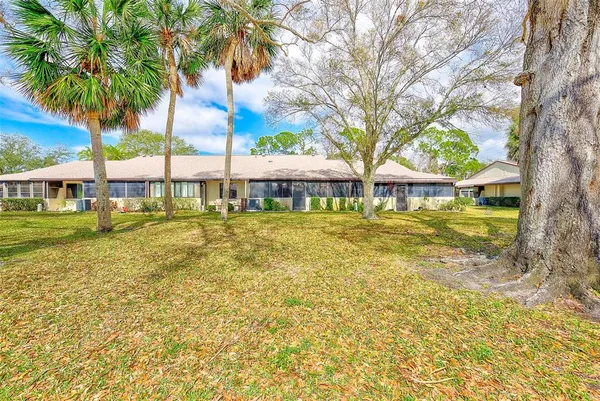 a view of swimming pool with outdoor seating and trees