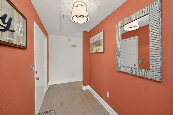 a view of a hallway with paintings on the wall