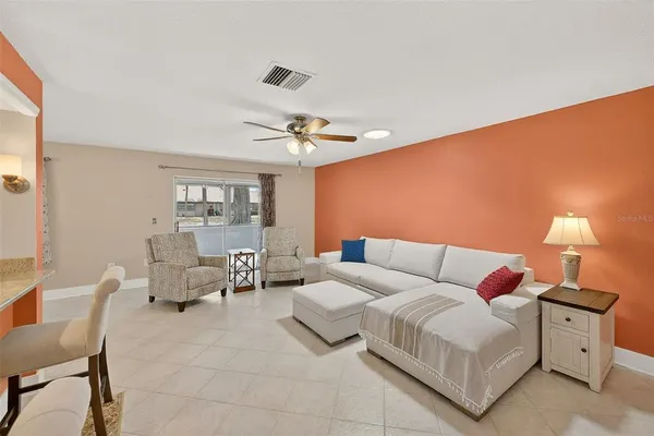 a living room with furniture and a lamp