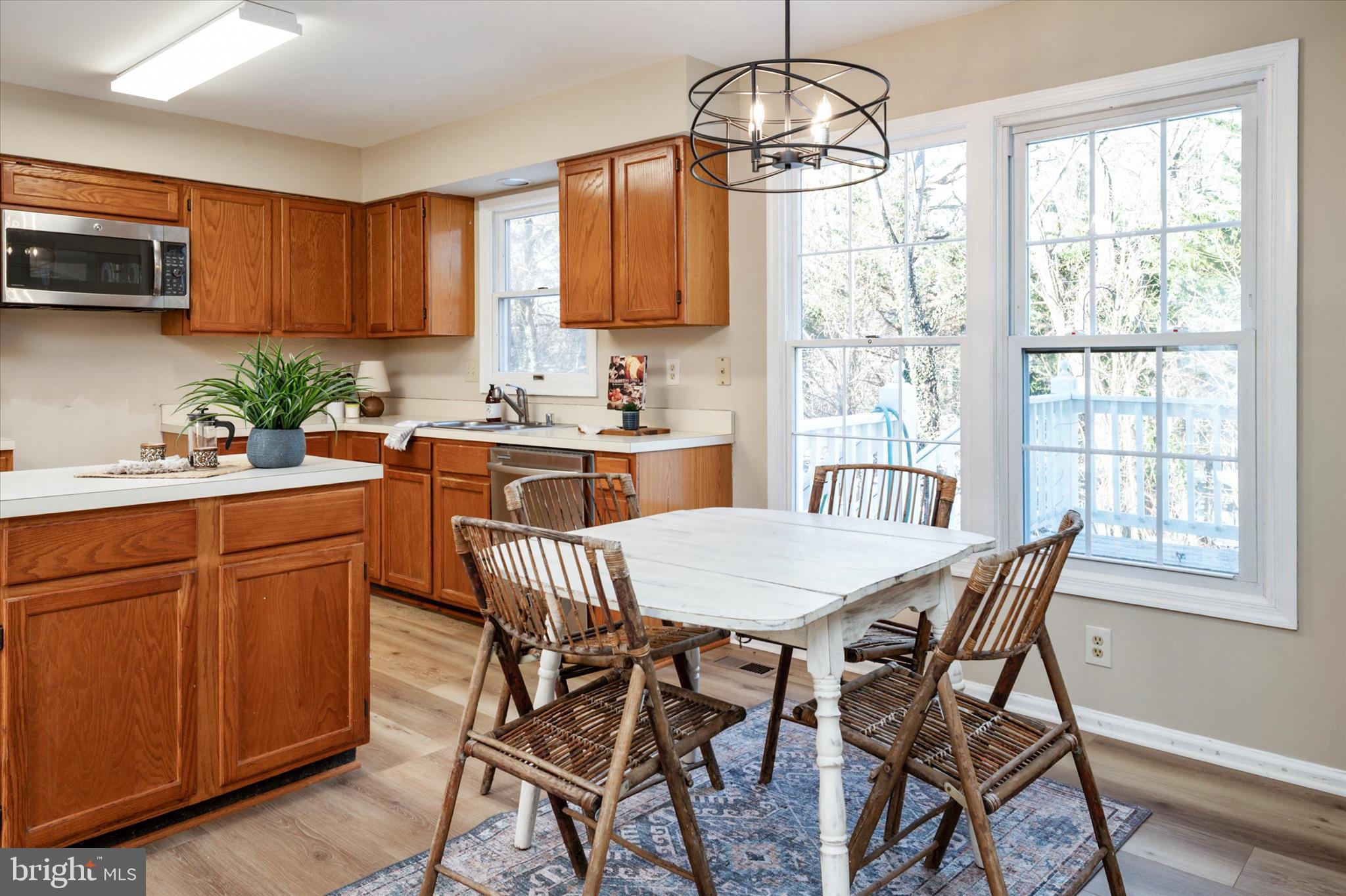 303 Pytchley Run Annapolis, MD 21403 - Photo 14 of 42 a kitchen with stainless steel appliances granite countertop wooden floor dining table and chairs
