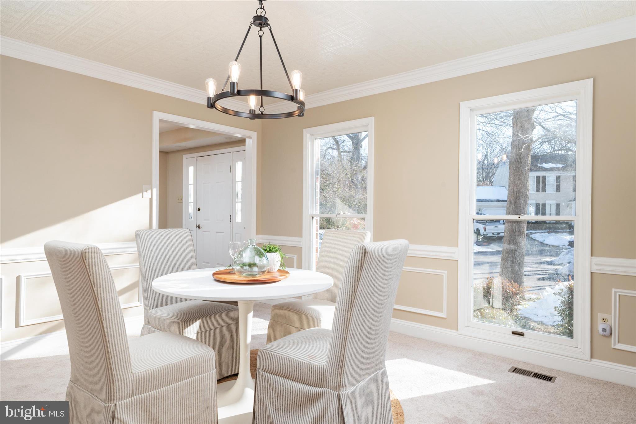 303 Pytchley Run Annapolis, MD 21403 - Photo 18 of 42 a dining room with furniture a chandelier and wooden floor