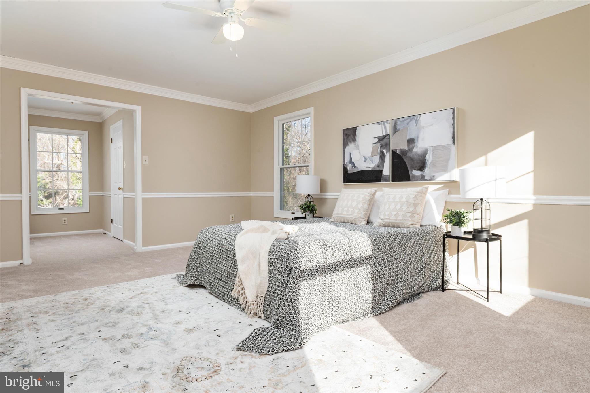 303 Pytchley Run Annapolis, MD 21403 - Photo 22 of 42 a bedroom with a large bed and a chandelier