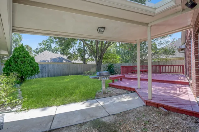 a view of a backyard with sitting area and garden
