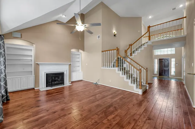 wooden floor in an empty room with a fireplace