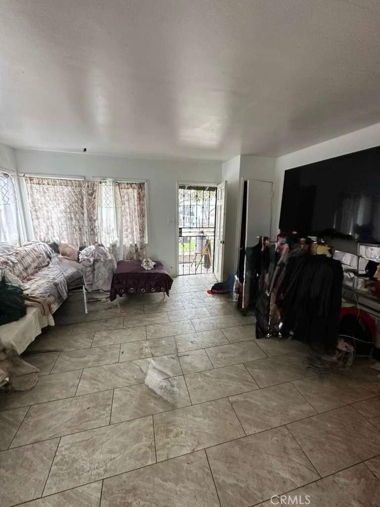 10401 State Street South Gate, CA 90280 - Photo 17 of 21 a living room with furniture and a flat screen tv