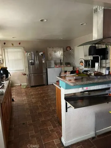a kitchen with a sink and a stove top oven