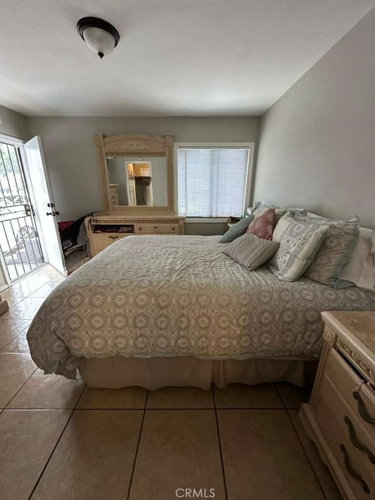10401 State Street South Gate, CA 90280 - Photo 7 of 21 a bedroom with a bed and window