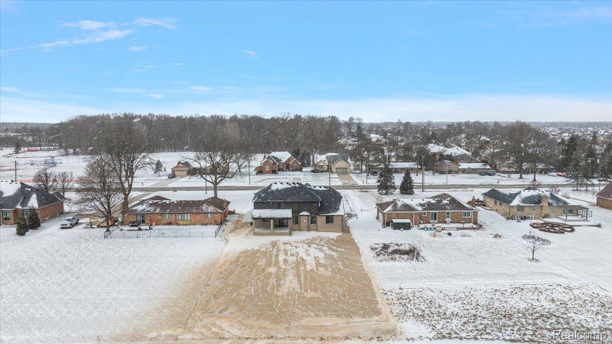 53650 Romeo Plank Road Macomb, MI 48042 - Photo 53 of 64 Snowy aerial view featuring a residential view
