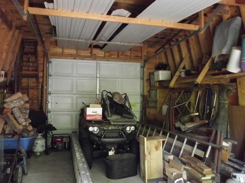 250 Arthur Allen Road Sumner, ME 04292 - Photo 13 of 34 Garage. Mower tractor