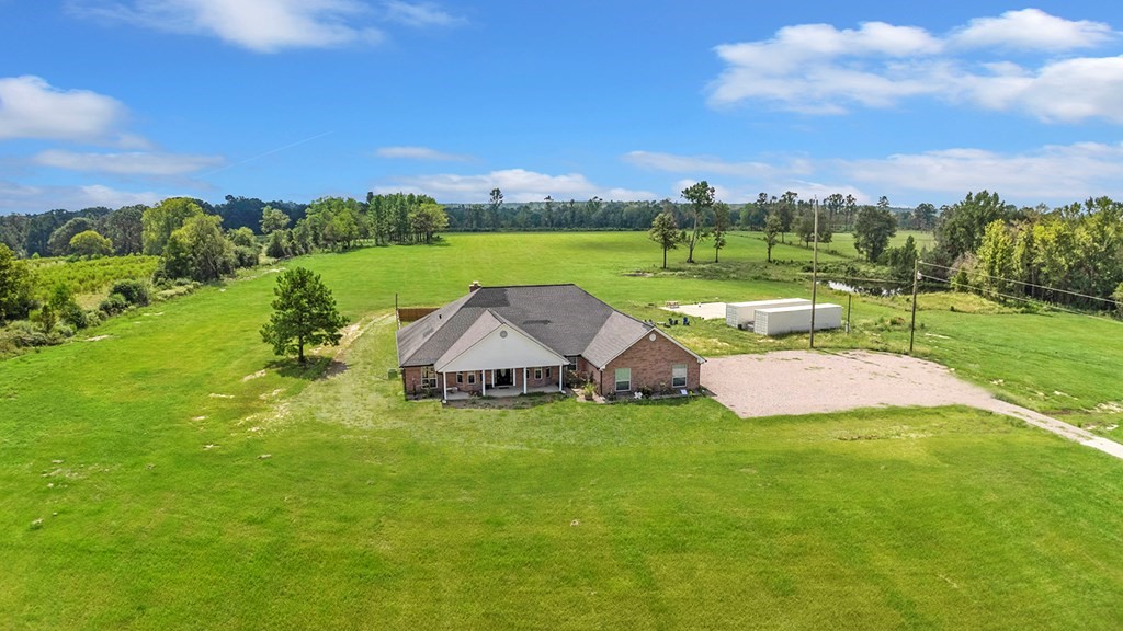 an aerial view of a house with big yard