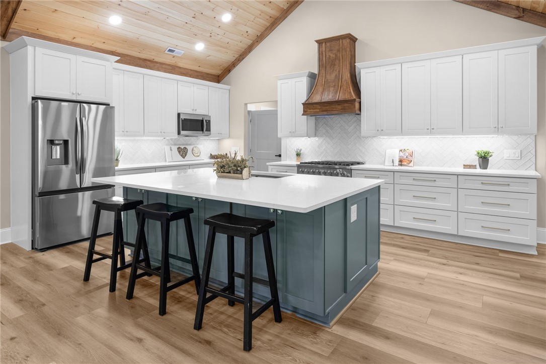 147 McAlister Road West Union, SC 29696 - Photo 9 of 50 Vaulted wood-clad ceilings and a substantial central island anchor this meticulously designed kitchen.