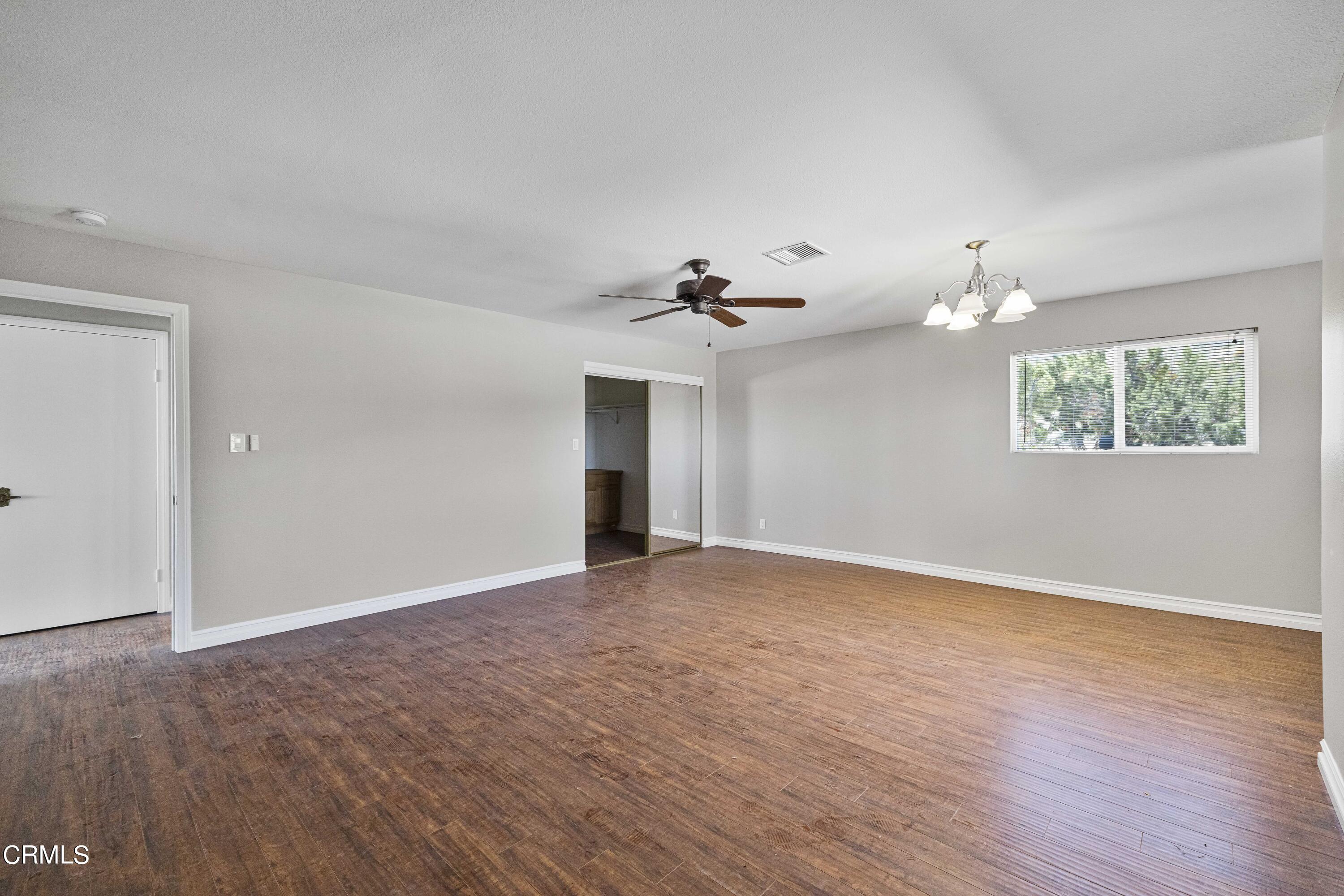 728 Nielson Road Pinon Hills, CA 92372 - Photo 24 of 50 a view of an empty room with wooden floor and a window