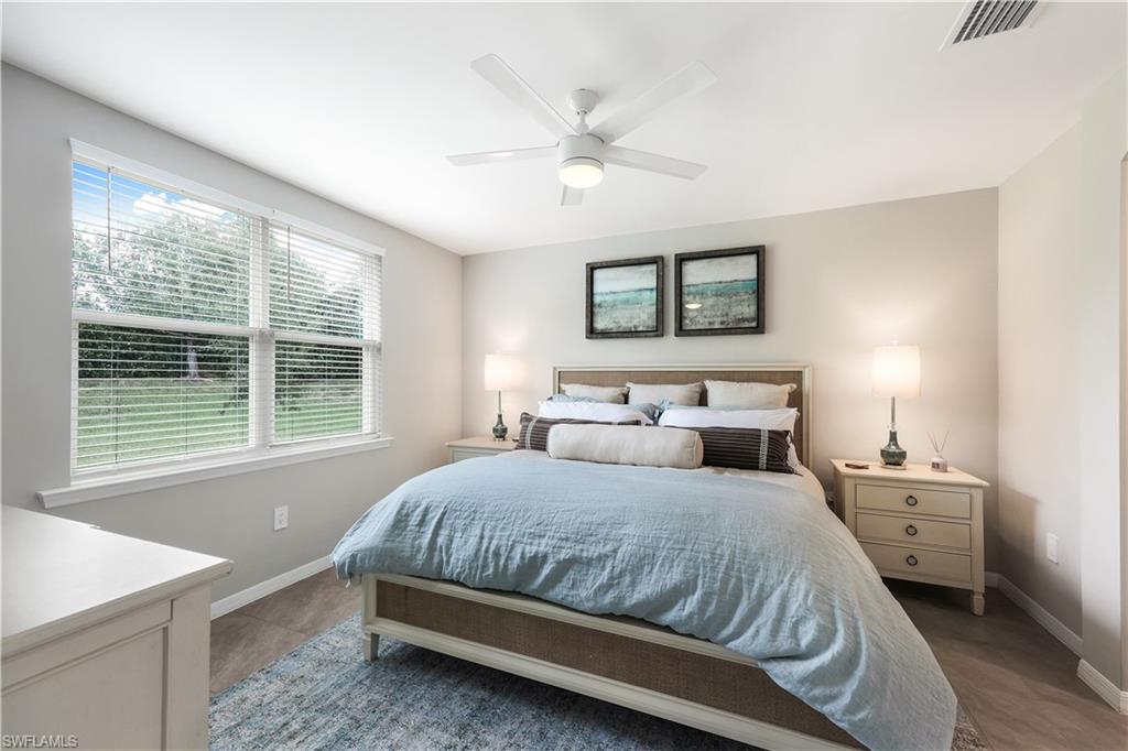 14551 Edgewater Circle Naples, FL 34114 - Photo 12 of 26 Bedroom featuring ceiling fan and baseboards