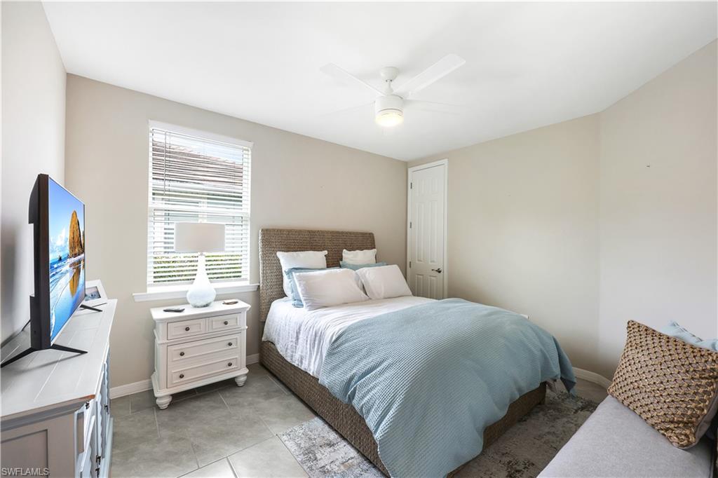 14551 Edgewater Circle Naples, FL 34114 - Photo 16 of 26 Bedroom featuring light tile patterned floors and ceiling fan