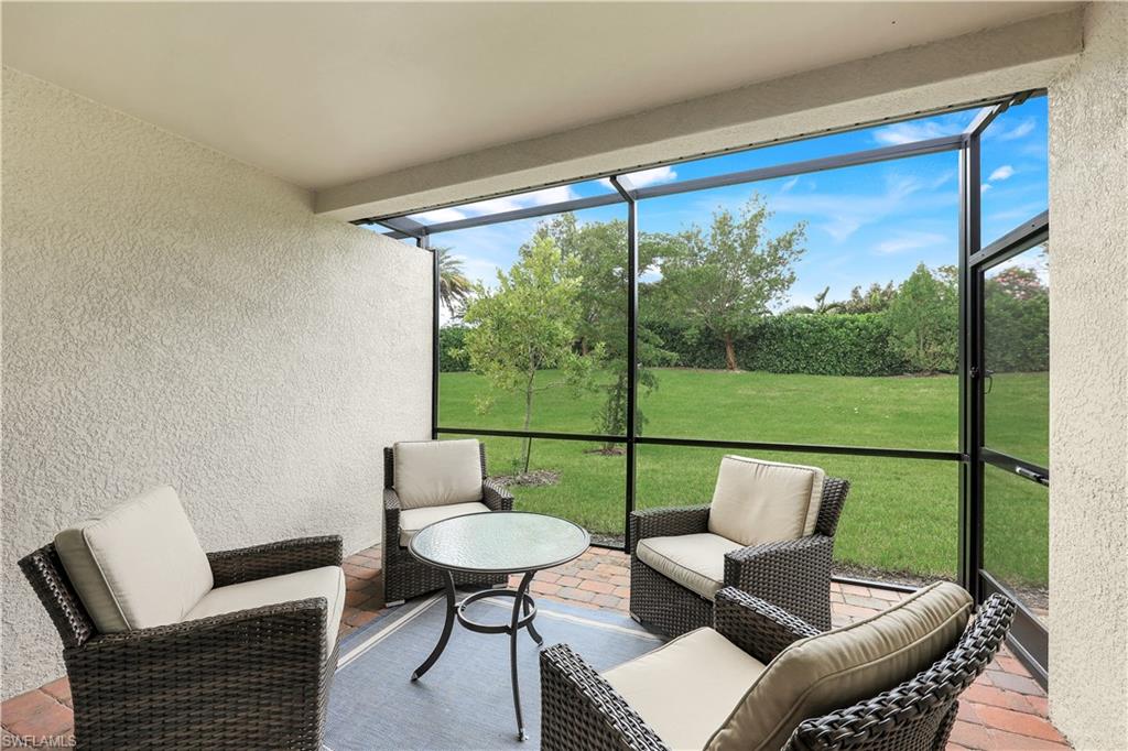 14551 Edgewater Circle Naples, FL 34114 - Photo 21 of 26 Sunroom with outdoor lounge area