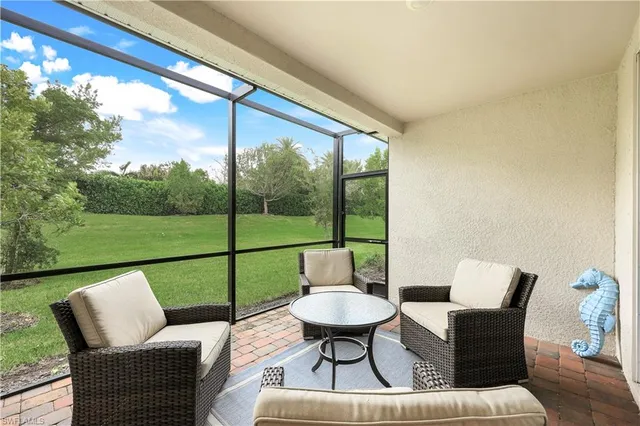 a balcony with couple of chairs and a table